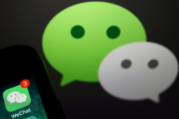 The messenger app WeChat is seen next to its logo in this illustration picture. 